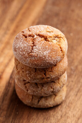 Stack of fresh sugar ginger cracked cookies on wooden table