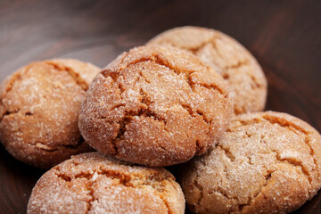 Crispy gingerbread cookies with textured cracked sugar crust in rustic bowl