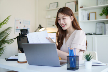 Smiling businesswoman explaining during a video conference call from her home office.