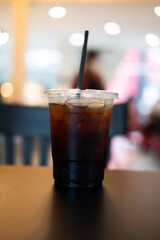 Closeup of take away plastic cup of iced black coffee Americano