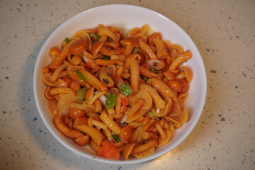 Mushrooms and herbs on a white plate on the table.
