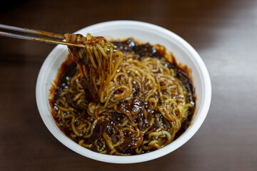 Korean food jajangmyeon, Black-bean-sauce noodles, a bowl of food with sauce on top