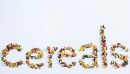 Cereal word made of dried fruits and nuts on white background