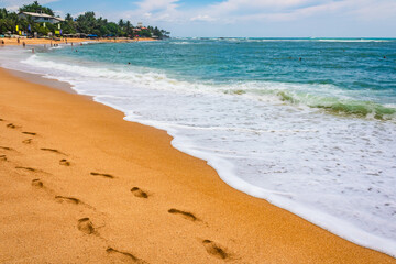 Landscape view of Unawatuna beach, footprints in the sand, Sri Lanka