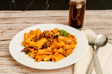 Delicious pasta with meat and vegetables enjoying with soda