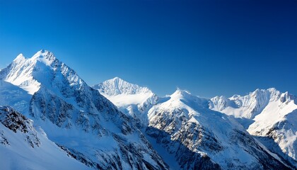 snow covered mountain range under a clear blue sky with bright sunlight