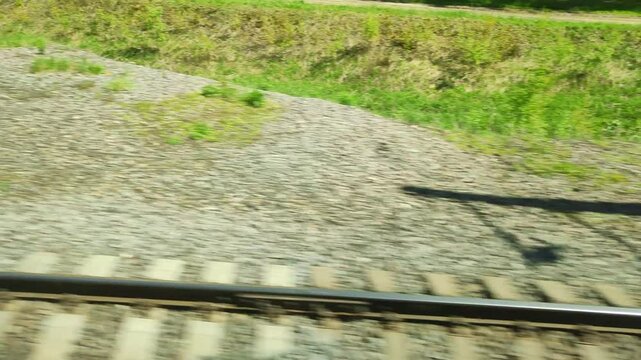 Rails and sleepers, side view when moving from a passing train. Travelers see railway tracks rushing past