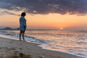 Meditating at sunrise on a tranquil beach