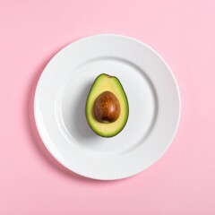 Half Avocado on White Plate Pink Background