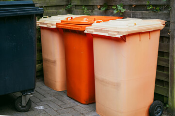 Colorful recycling bins on city street
