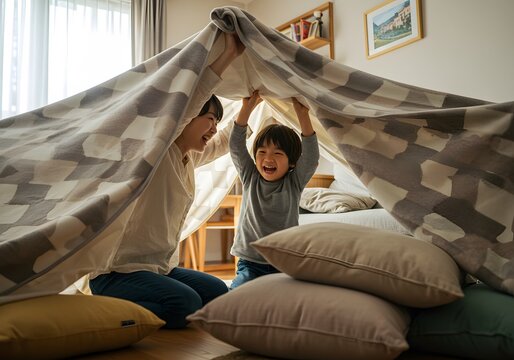 Candid Indoor Shot of Happy Family Building Blanket Fort Together