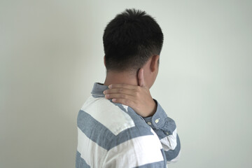 An asian unhappy and annoyed business man is suffering headache and stresses, closing his ears with...