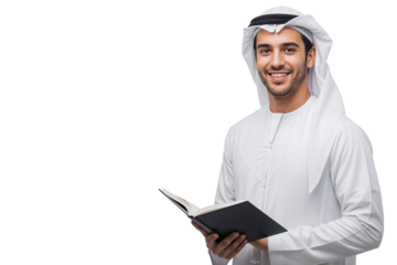 Smiling young Arab man in traditional clothes holding an open book and looking at the camera. Studio shot with ample copy space