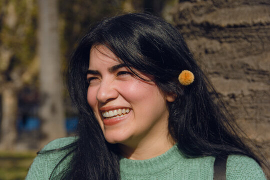 young happy Venezuelan woman looking and smiling, close-up.