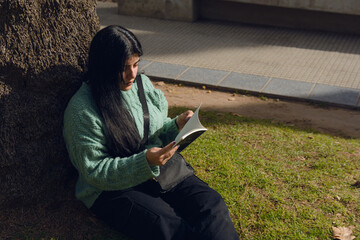 young woman concentrated reading in the park