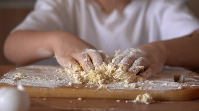 Child enjoys making dough from scratch in home kitchen while learning baking skills and having fun
