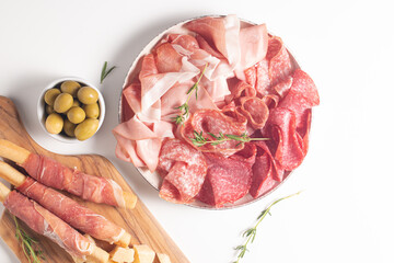 Charcuterie board. Antipasti appetizers of meat platter with salami, prosciutto crudo or jamon and olives.