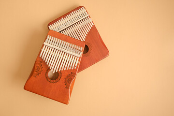 two wooden kalimbas on beige background, traditional african musical instrument, meditation instrument, copy space top view