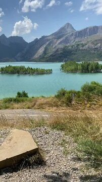 Scenic view of a reservoir Pico Gilbo and mountains from a bench under a tree in Ria&ntilde;o, Spain