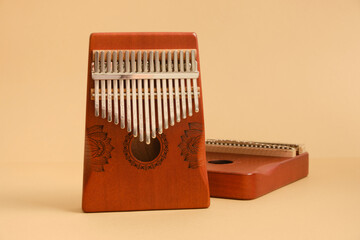 wooden kalimba on beige background, traditional african musical instrument, meditation instrument, copy space