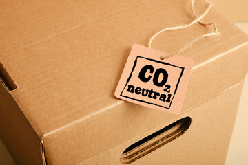 tag with the inscription co2 neutral on cardboard storage box and label mockup, close up, kraft box