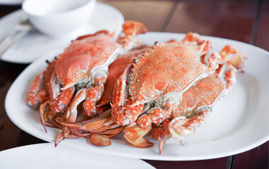 Fresh sea crabs cooked by charcoal grilling, served on the dish with Thai seafood dipping sauce at the famous local restaurant in Thailand.