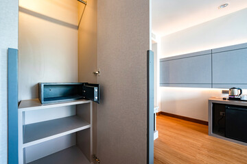 Opened Unlock digital modern Black Safe box, Stroungbox on the shelf in wood Closet in Hotel room