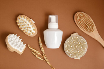 wheat, white mock up bottle with dispenser and massage brushes, massagers made of natural wood and bamboo, eco friendly care for face, hair and body