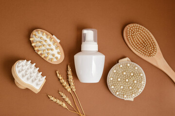wheat, white mock up bottle with dispenser and massage brushes, massagers made of natural wood and bamboo, eco friendly care for face, hair and body