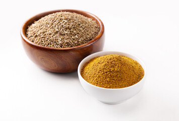 Indian food spice called cumin and cumin powder spice powder masala powder in wooden bowl isolated on white background