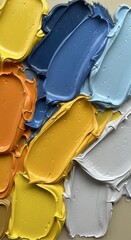 Smooth layered strokes of oil paint in yellow, blue, orange, and grey arranged in a vibrant abstract composition. Concept of color harmony, minimal expression, and creative texture design.