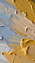 Close-up of abstract oil paint strokes in pastel blue, beige, and mustard yellow tones with thick texture. Concept of modern visual art, interior style, and creative mood expression.