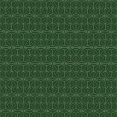 Geometric seamless pattern with triangle shapes in alternating colors of dark and light green, suitable for fabric or background design