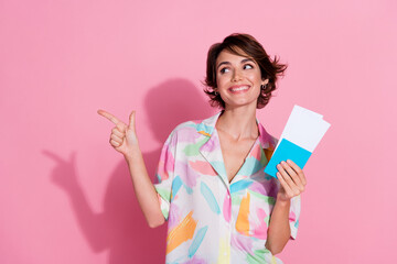 Portrait of nice young lady passport point finger empty space wear shirt isolated on pink color...