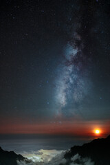Milky Way and moonset above the clouds