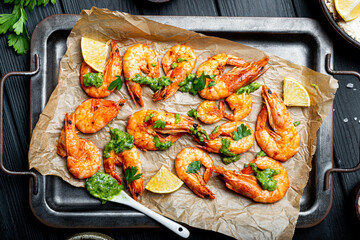  Fried shrimps with lemon and green on a metal tray, top view, copy space for text