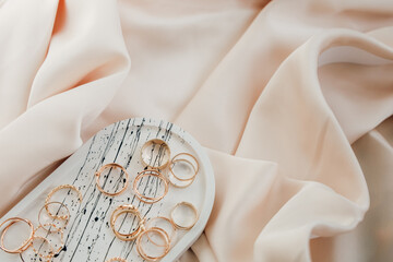 Delicate jewelry arrangement on soft fabric showcases elegant craftsmanship and design