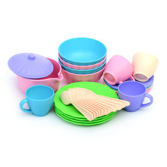 A set of toy colored plastic tableware on a white background.