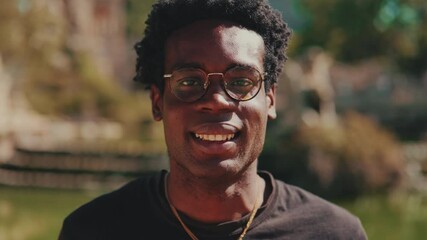 Portrait of a Happy Young Man Smiling in a Park