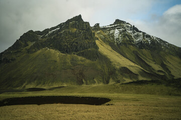 Icelandic Hills under Heavy Clouds
Rolling hills of Iceland lie below a blanket of dark clouds,...