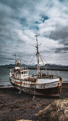 Abandoned Fishing Boat on Black Beach
Resting on a black sand beach, it stands weathered and rusted...