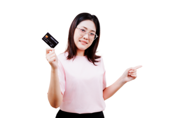 A smiling Asian beautiful young woman wearing glasses holds a credit card in one hand while pointing with the other, dressed in a light pink shirt.