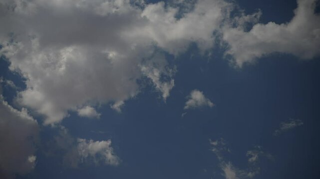 Clouds time lapsed over blue sky