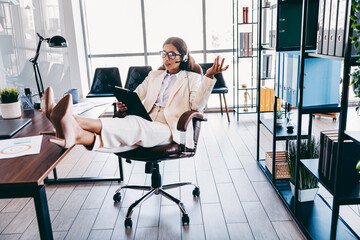 Charming businesswoman working confidently in a modern corporate office space while speaking and...