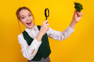 Young female student examines a sample with curiosity and excitement in a vibrant studio setting