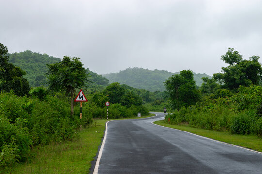 Winding road through green forest hills, Purulia during rainy season