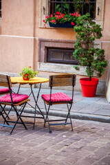 Outdoor Cafe Seating on Street. Chairs and tables in blue. Old tourist town in summer. Vacation