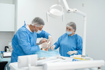 Obraz premium Dentist and female nurse making professional teeth cleaning eldery woman at dental office. Teamwork