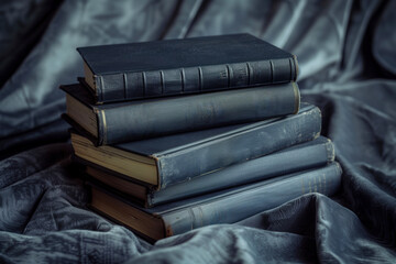Stack of black hardcover books on dark background
