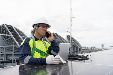 Solar panel rooftop, Rooftop solar power. Engineer using laptop computer inspecting installation and control quality of solar panel on rooftop of building